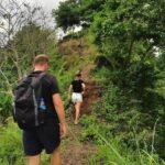 Guests hiking together toward rest point during waterfall hike in Lombok