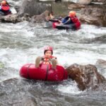 Participants floating on inflatable tubes along Babak River